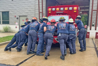 Firefighters push the new fire truck into the station as a part of a centuries-old traditional push-in ceremony. Photos by Adriana Gasiewski