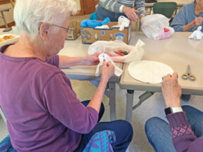 Handcrafters Club member Oriann Crow wraps a white sheet around a Tootsie Pop. Photos by Adriana Gasiewski